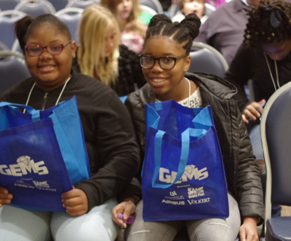 Two students holding their GEMS bags.